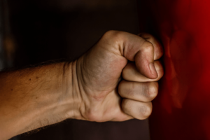 Man hitting fist against the wall