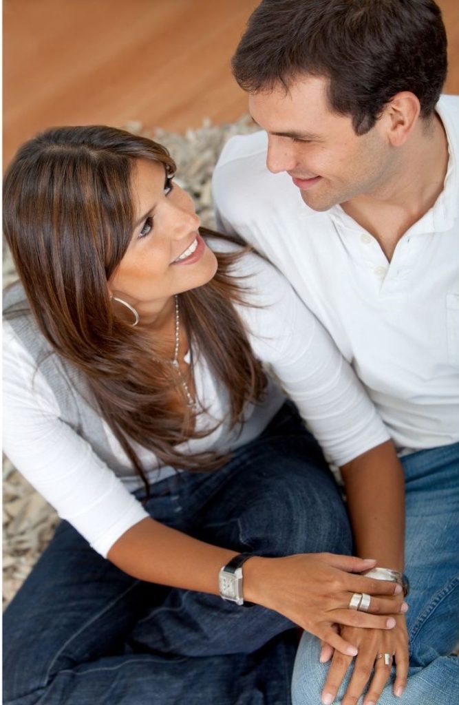 man and woman talking, woman looking up at man and smiling