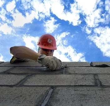 A man laying bricks