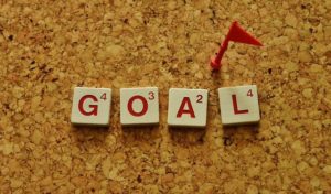 The word "goal" spelled in scrabble tiles