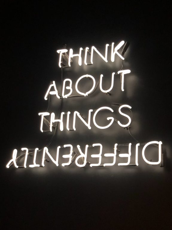 Text on a black background; the text reads, "Think about things differently," and the last word ("differently") is upside down.