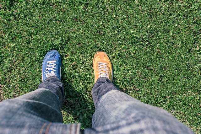 A 1st-person view of mismatched shoes