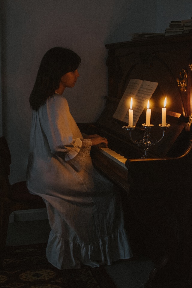 A young woman playing a piano